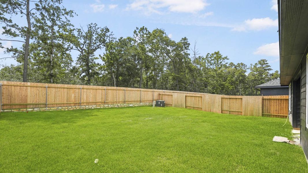 Exterior details and patio area of a home in Grand Pines, Magnolia (Image 3). Exterior details and patio area of a home in Grand Pines, Magnolia (Image 3).