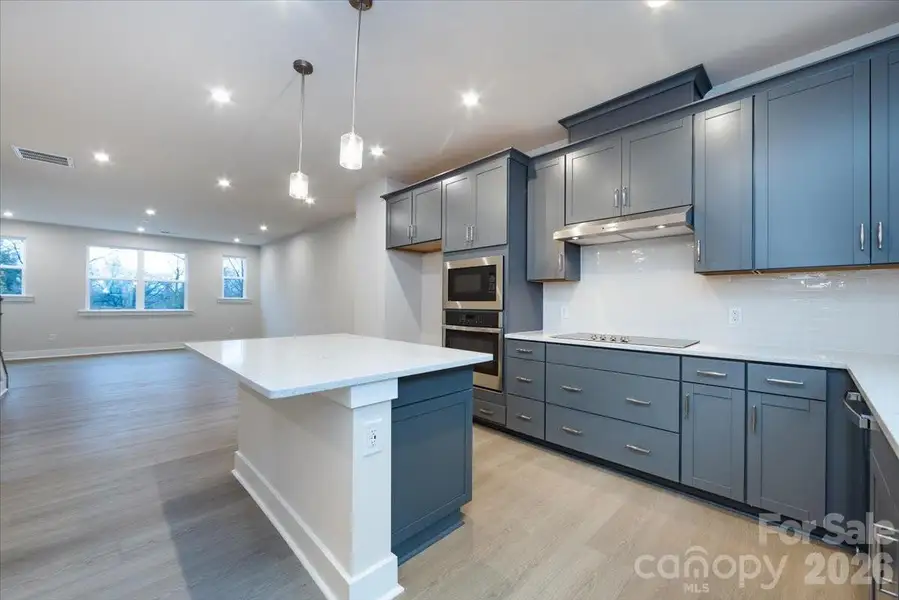 Gourmet kitchen with rich grey cabinets