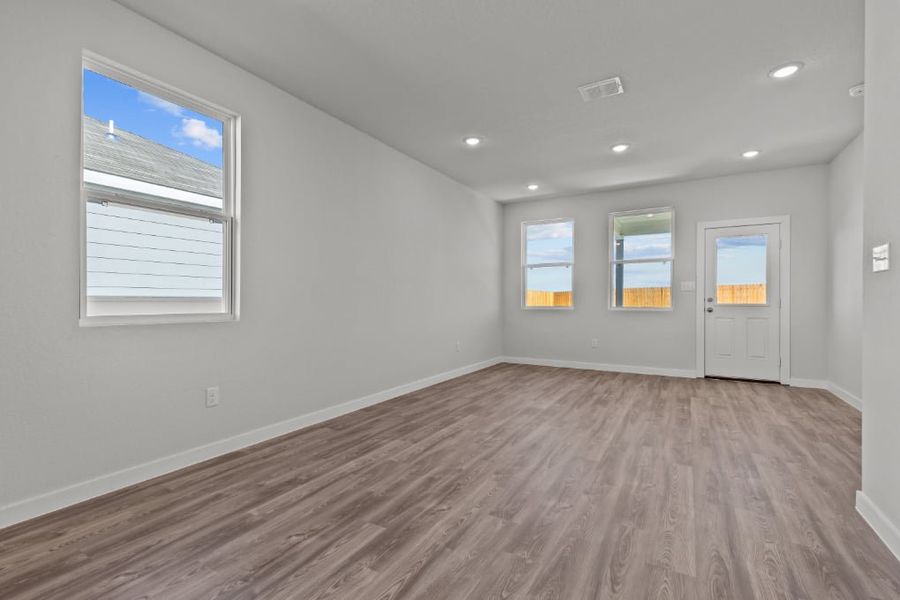 A room with a wood floor and white walls.