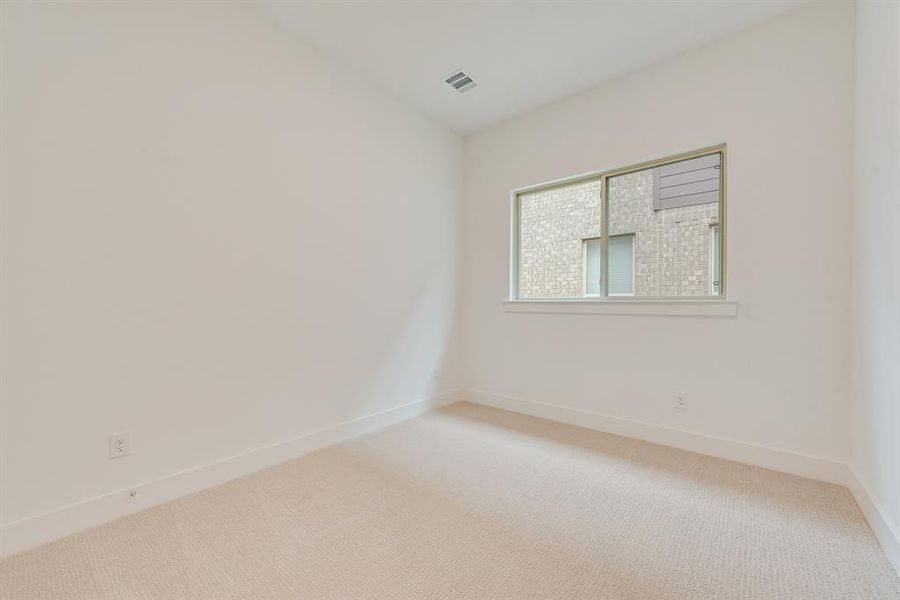 Unfurnished room with carpet floors and baseboards Unfurnished room with carpet floors and baseboards