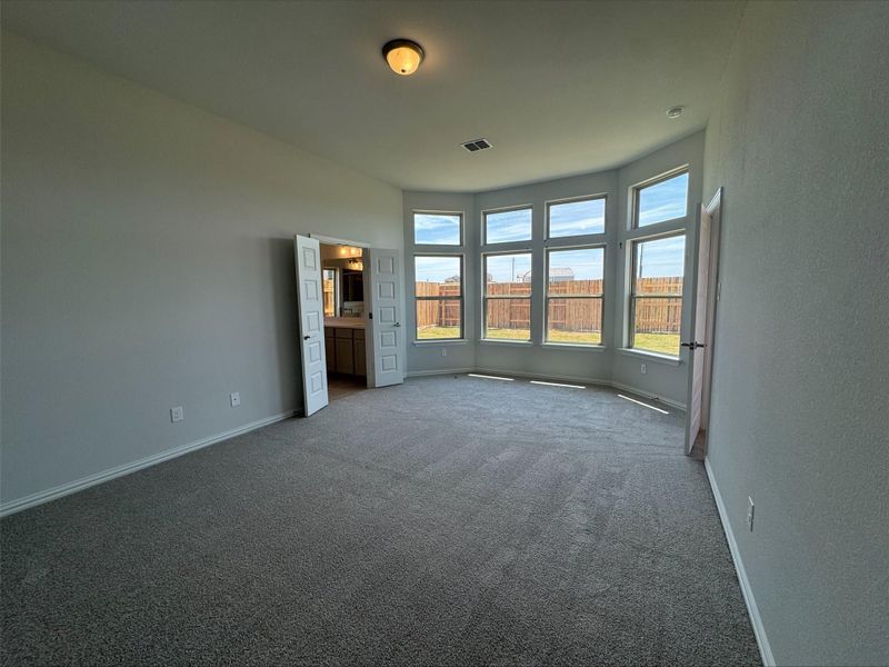 Unfurnished bedroom featuring carpet flooring and baseboards Unfurnished bedroom featuring carpet flooring and baseboards
