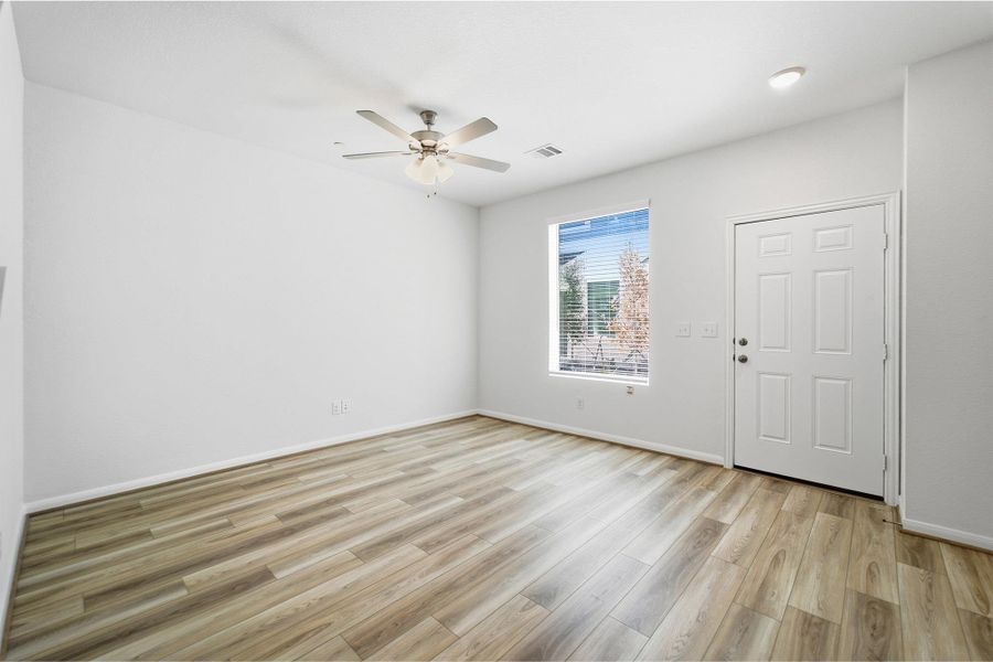 Unfurnished room with a ceiling fan and light wood finished floors Unfurnished room with a ceiling fan and light wood finished floors