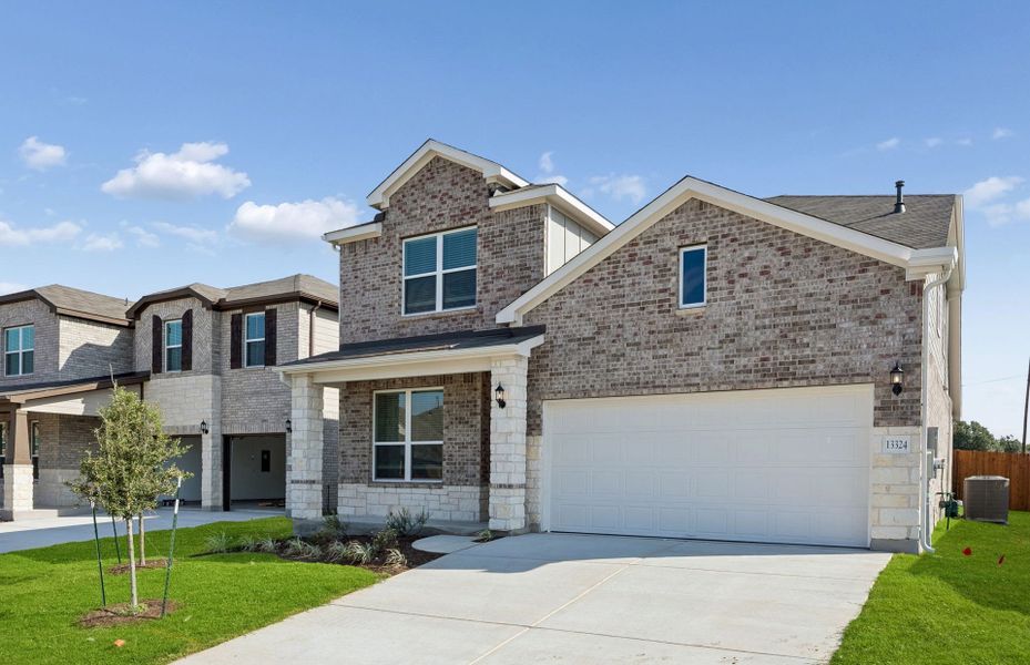 Front exterior of a new home in Lagos, Manor, TX, highlighting curb appeal (Image 2). Front exterior of a new home in Lagos, Manor, TX, highlighting curb appeal (Image 2).