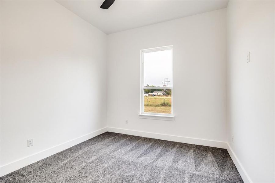 Unfurnished room featuring carpet floors and a ceiling fan Unfurnished room featuring carpet floors and a ceiling fan