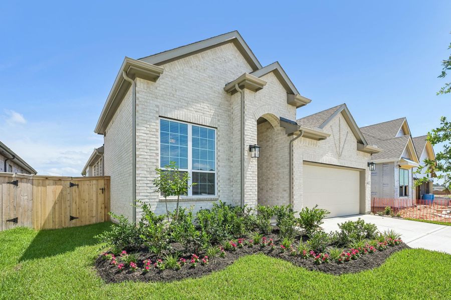 Front exterior of a new home in Wood Leaf Reserve, Tomball, TX, highlighting curb appeal (Image 1). Front exterior of a new home in Wood Leaf Reserve, Tomball, TX, highlighting curb appeal (Image 1).