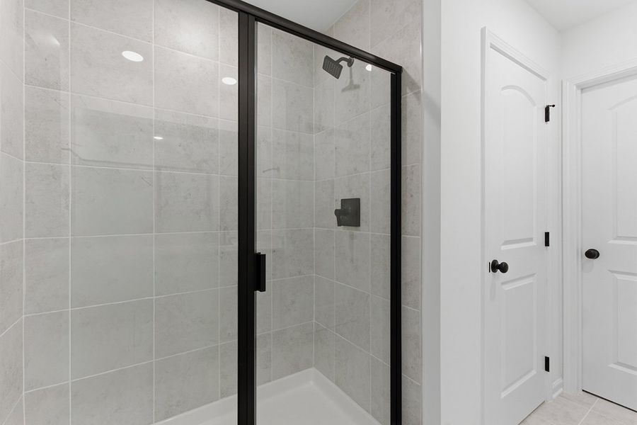 A shower with glass doors.