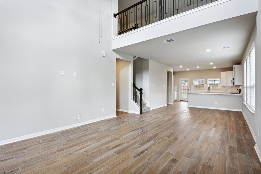 Living room and dining room in the Medina floorplan at a Meritage Homes community.