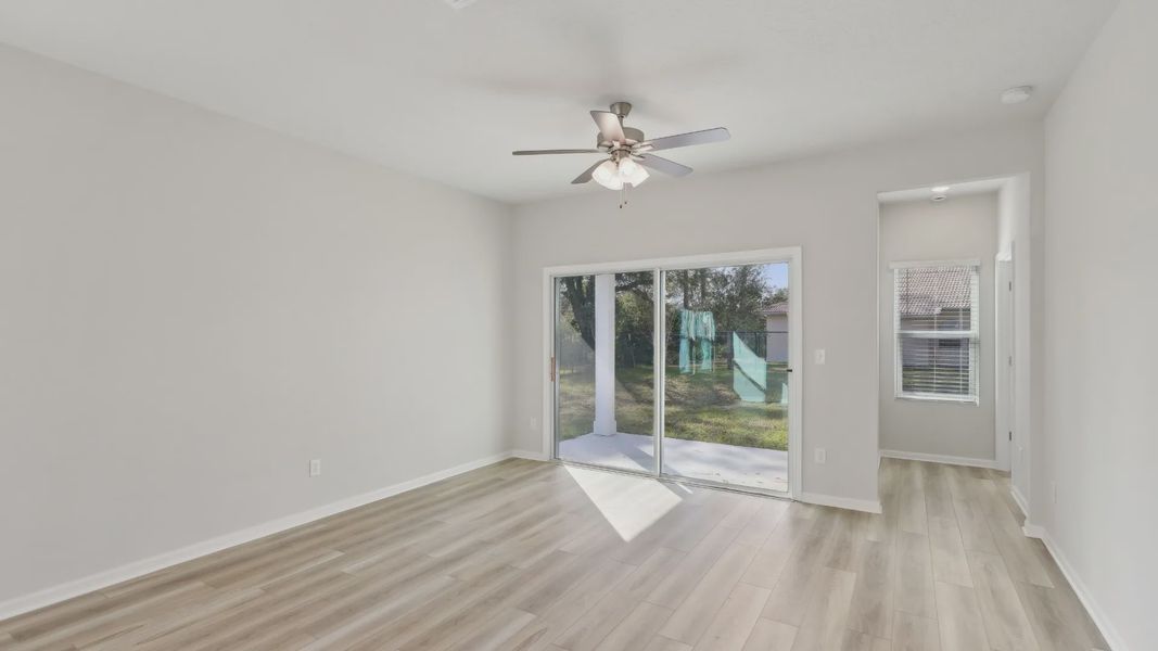 Elegantly crafted light wood floors and expansive sliding doors in Palm Coast residence.