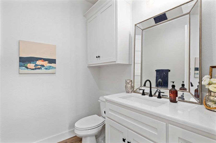 Bathroom featuring vanity and wood finished floors