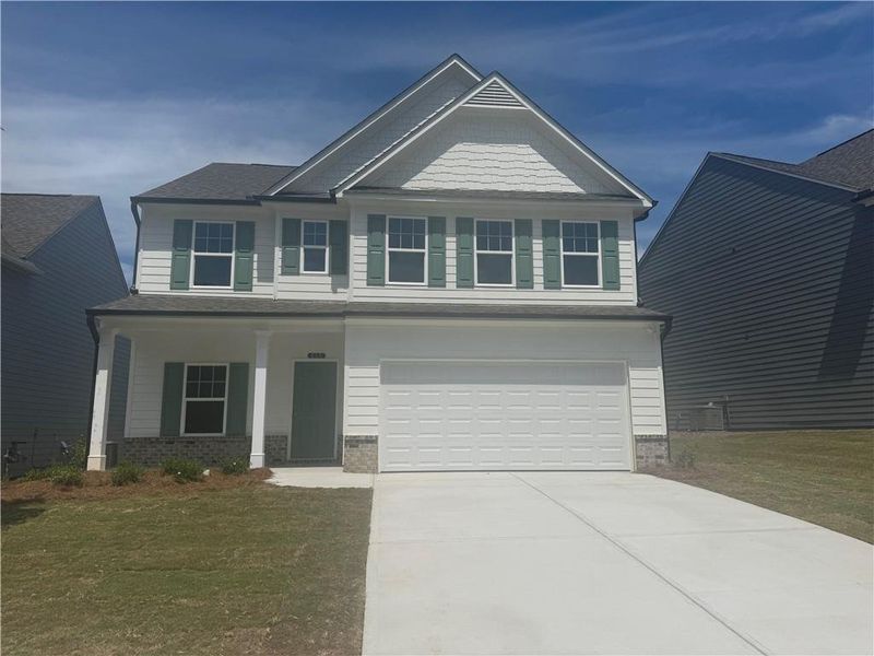 Front exterior of a new home in The Reserve at Willow Oaks, Canton, GA, highlighting curb appeal (Image 1).