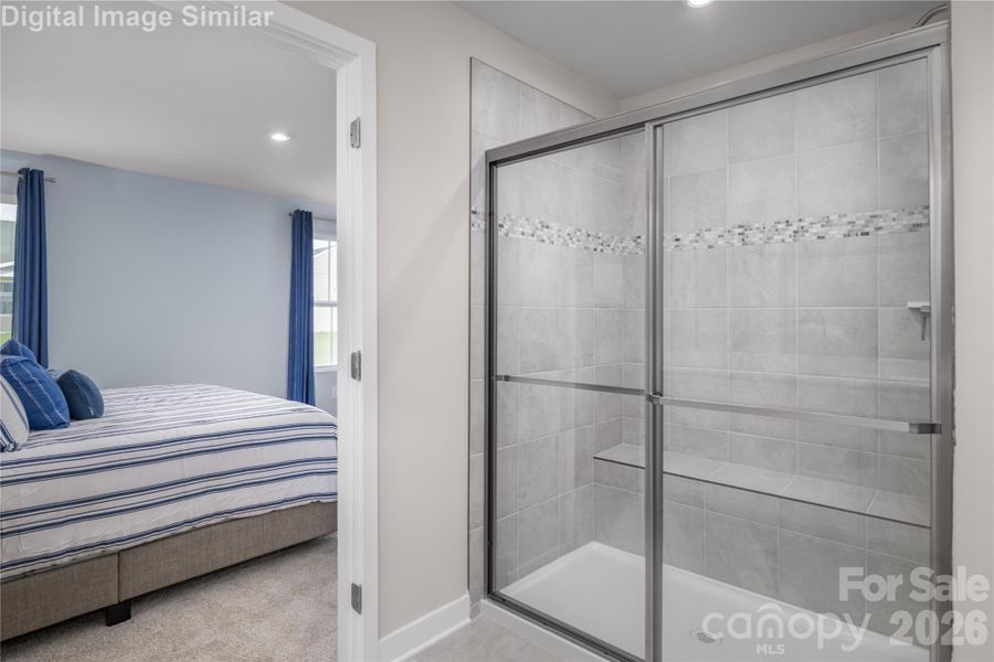 Relax and refresh in this chic ensuite with framed shower.