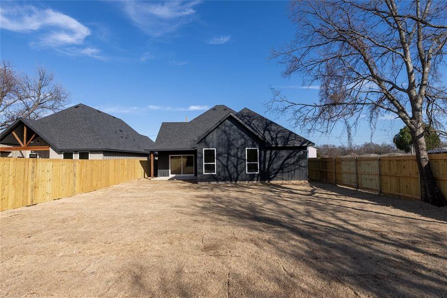 Back of house featuring a fenced backyard and a patio