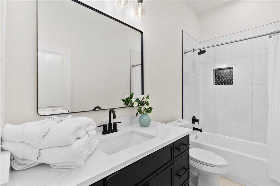 Bathroom with vanity, toilet, and shower / bath combo with shower curtain Bathroom with vanity, toilet, and shower / bath combo with shower curtain