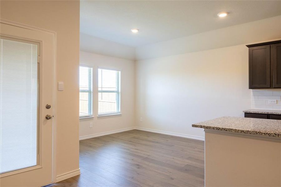 Unfurnished dining area featuring dark wood-type flooring and recessed lighting Unfurnished dining area featuring dark wood-type flooring and recessed lighting