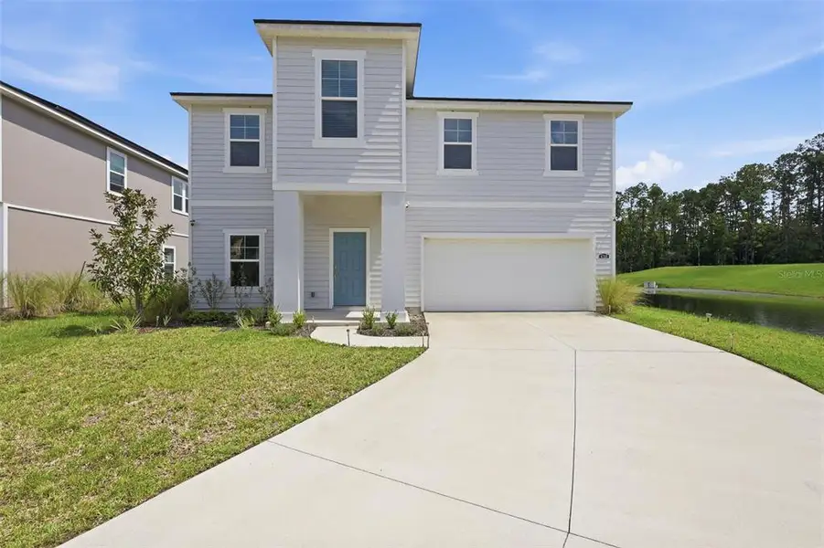Front exterior of a new home in Dunns Crossing, Jacksonville, FL, highlighting curb appeal (Image 28). Front exterior of a new home in Dunns Crossing, Jacksonville, FL, highlighting curb appeal (Image 28).