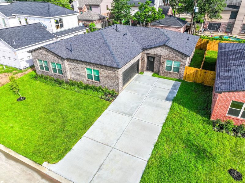 Large lot with defined concrete curbs and driveway