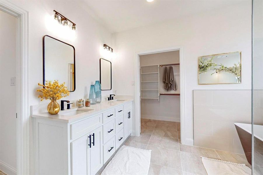 Bathroom with vanity, tile patterned floors, and a tub