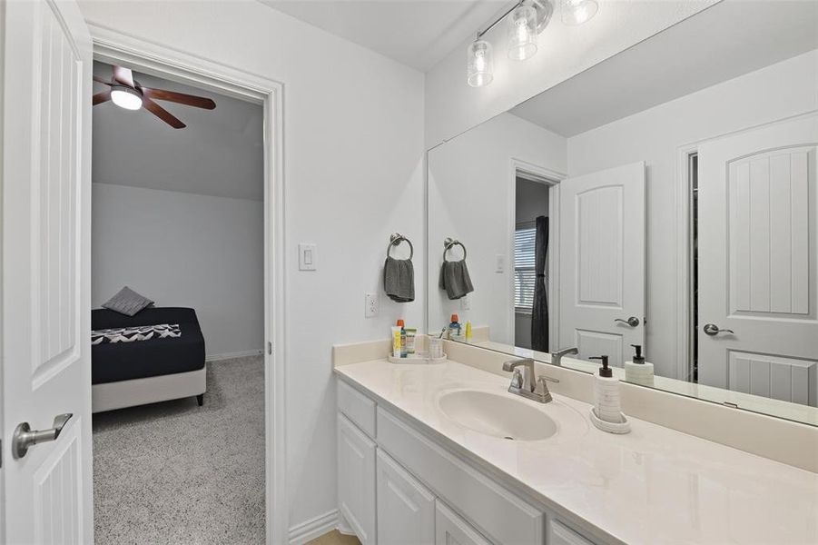 Bathroom featuring vanity and baseboards Bathroom featuring vanity and baseboards
