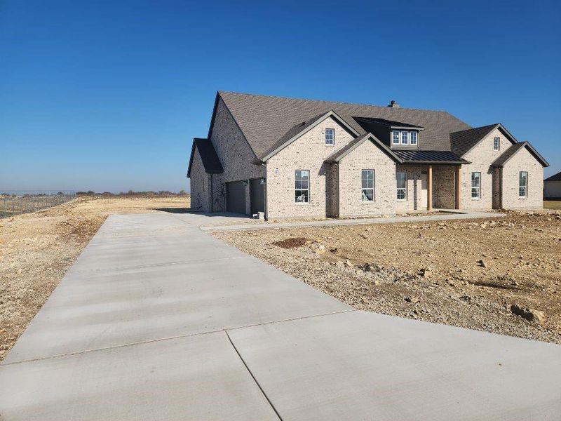 Front exterior of a new home in Rocky Top, Krum, TX, highlighting curb appeal (Image 1). Front exterior of a new home in Rocky Top, Krum, TX, highlighting curb appeal (Image 1).