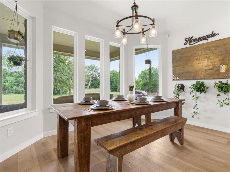 Light-filled dining space overlooking the property, offering scenic acreage views.