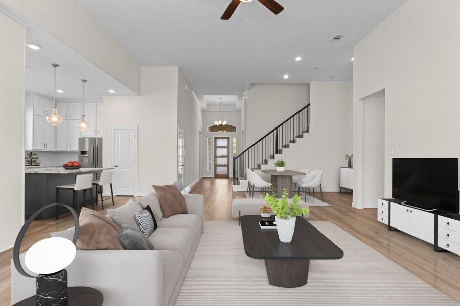 Open-concept view from the kitchen to the family room highlights the seamless flow and abundance of natural light. *Virtually Staged*
