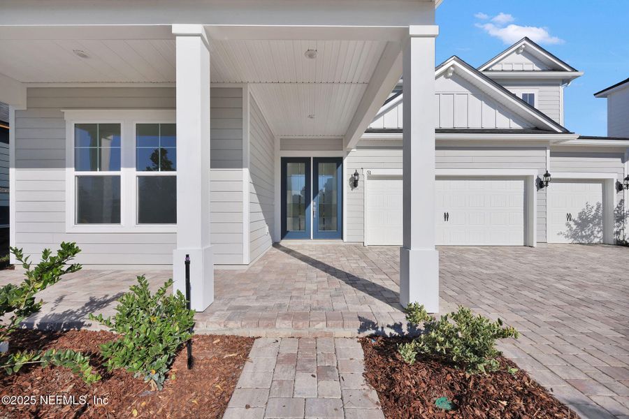 Exterior details and patio area of a home in The Landings at Saint Johns, St. Johns (Image 1).
