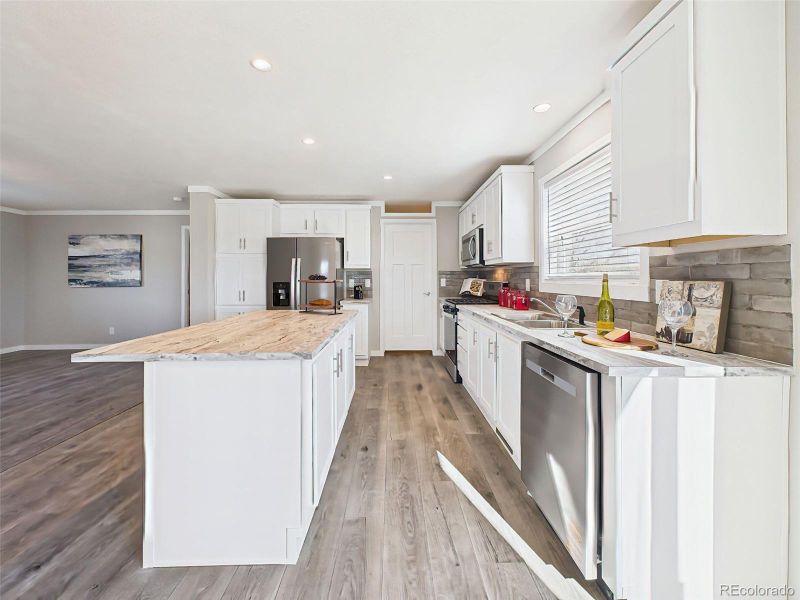 Open Layout from Kitchen – From the island, enjoy views across the light-filled living and dining areas, highlighting the home’s open-concept design and effortless flow.
