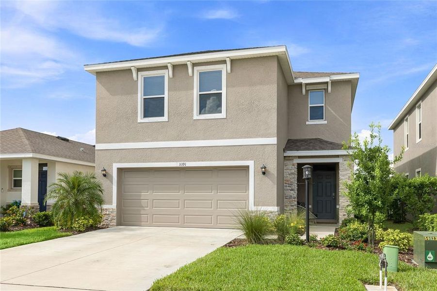 Front exterior of a new home in Star Farms at Lakewood Ranch, Bradenton, FL, highlighting curb appeal (Image 2). Front exterior of a new home in Star Farms at Lakewood Ranch, Bradenton, FL, highlighting curb appeal (Image 2).