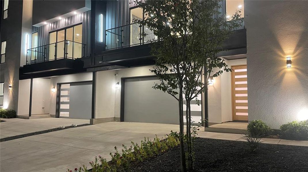 Property entrance featuring a balcony and a garage