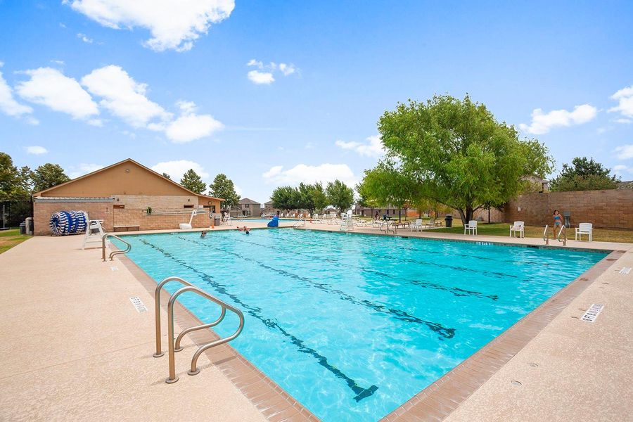 A refreshing community pool invites residents to relax and enjoy the clear water on a sunny day.