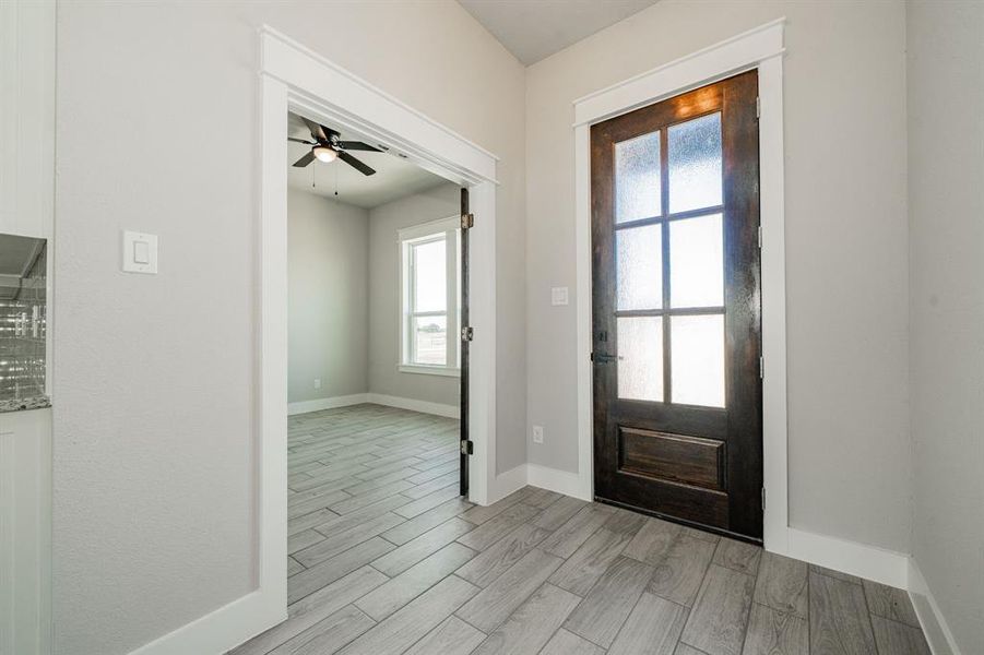 Foyer featuring wood finish floors and tile flooring Foyer featuring wood finish floors and tile flooring