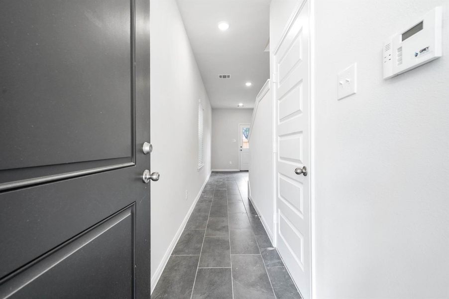 The front entryway leads to the 1st floor, where a secondary bedroom and en-suite full bath await. The front entryway leads to the 1st floor, where a secondary bedroom and en-suite full bath await.