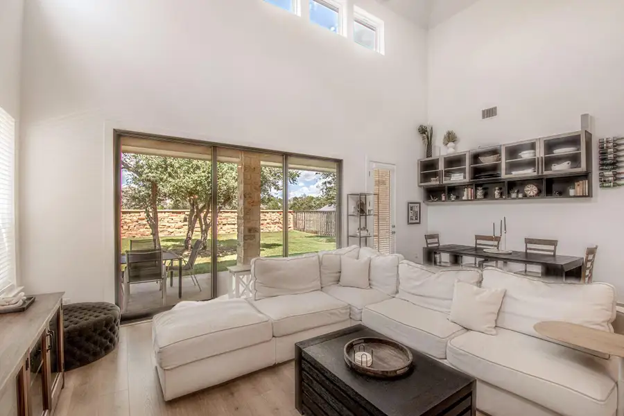 The open-concept living area flows seamlessly to the outdoors with the oversized wall of sliding glass doors.