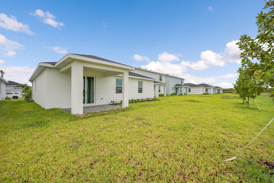 Front exterior of a new home in Seagrove: The Indies, Fort Pierce, FL, highlighting curb appeal (Image 2). Front exterior of a new home in Seagrove: The Indies, Fort Pierce, FL, highlighting curb appeal (Image 2).