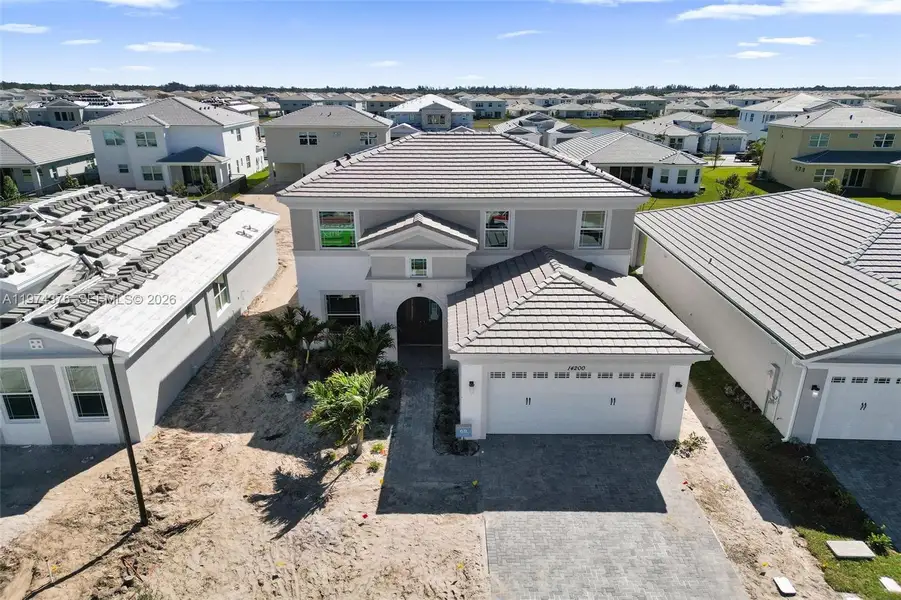Front exterior of a new home in , Westlake, FL, highlighting curb appeal (Image 2). Front exterior of a new home in , Westlake, FL, highlighting curb appeal (Image 2).