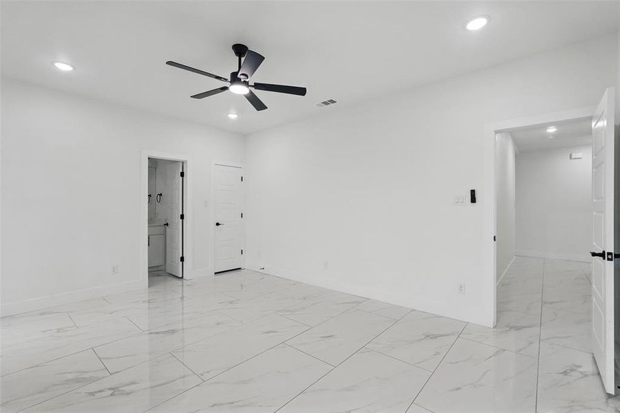 Empty room featuring light marble finish floors, recessed lighting, baseboards, and a ceiling fan Empty room featuring light marble finish floors, recessed lighting, baseboards, and a ceiling fan