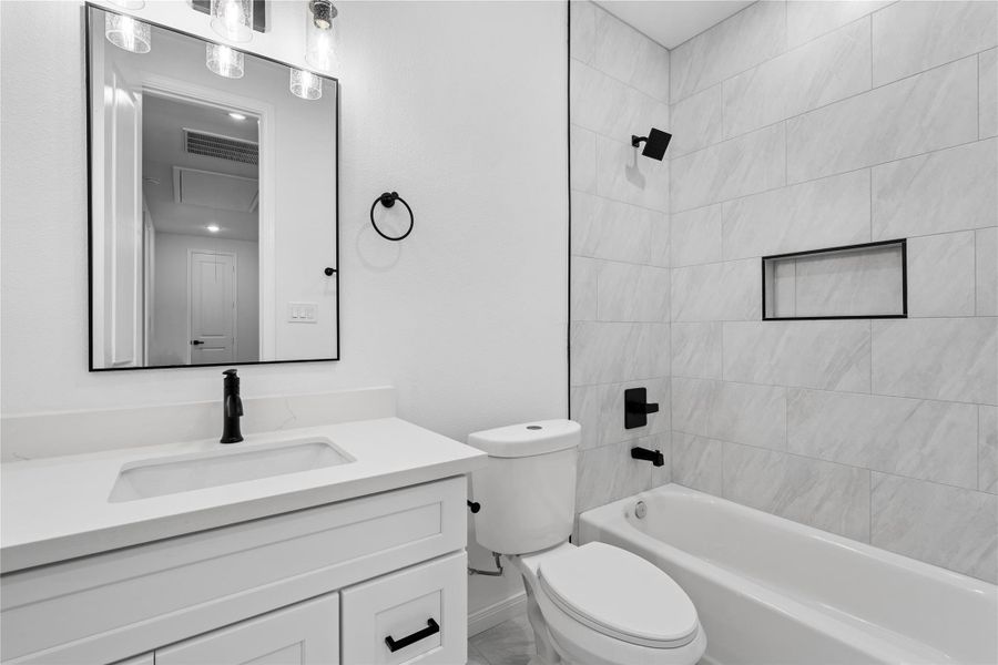 Modern full bath with sleek finishes, serving the secondary bedrooms with style and convenience.