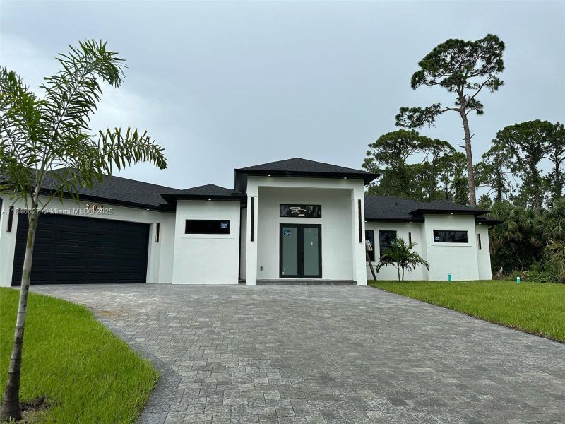 Front exterior of a new home in , Lehigh Acres, FL, highlighting curb appeal (Image 2).