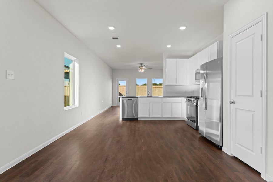 Beautiful open-concept layout where the dining area flows seamlessly into the stylish kitchen and family room! Gorgeous vinyl plank wood floors, high ceilings, and natural light make this space feel bright and welcoming. Beautiful open-concept layout where the dining area flows seamlessly into the stylish kitchen and family room! Gorgeous vinyl plank wood floors, high ceilings, and natural light make this space feel bright and welcoming.