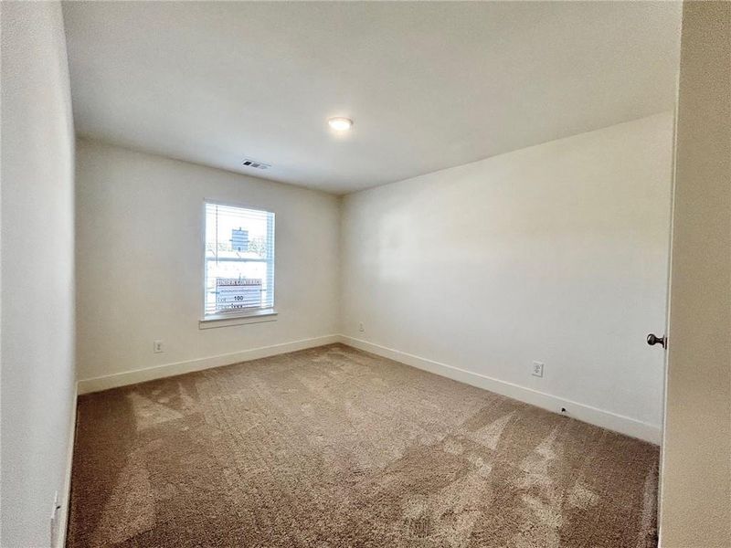 Unfurnished room featuring dark colored carpet