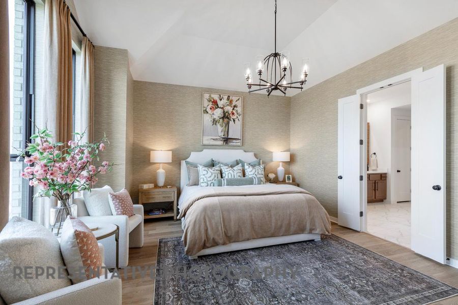 Bedroom with a chandelier and vaulted ceiling