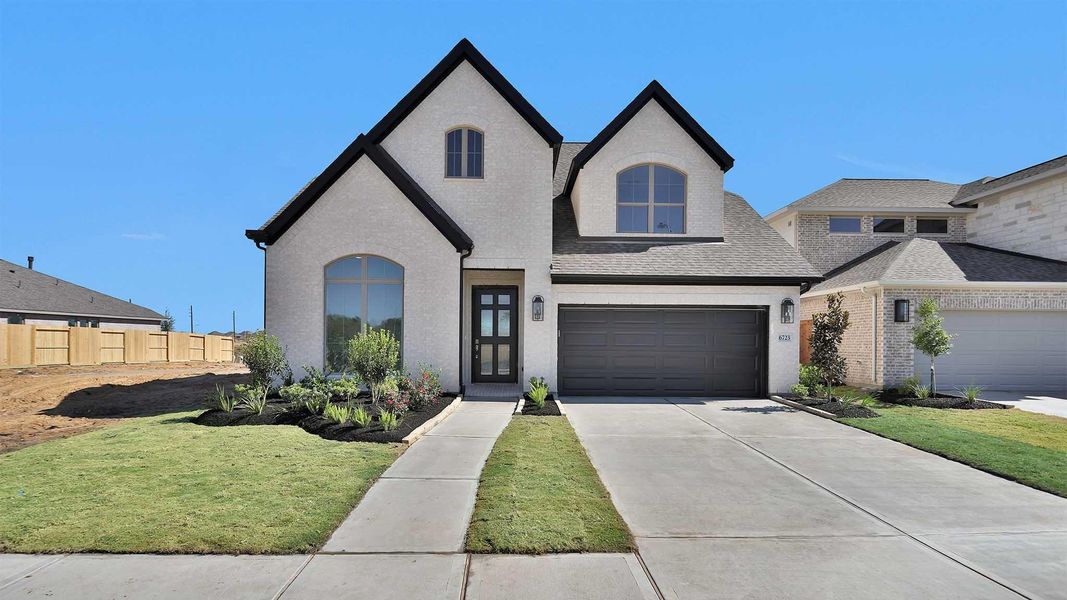Front exterior of a new home in Valencia 50', Manvel, TX, highlighting curb appeal (Image 1). Front exterior of a new home in Valencia 50', Manvel, TX, highlighting curb appeal (Image 1).