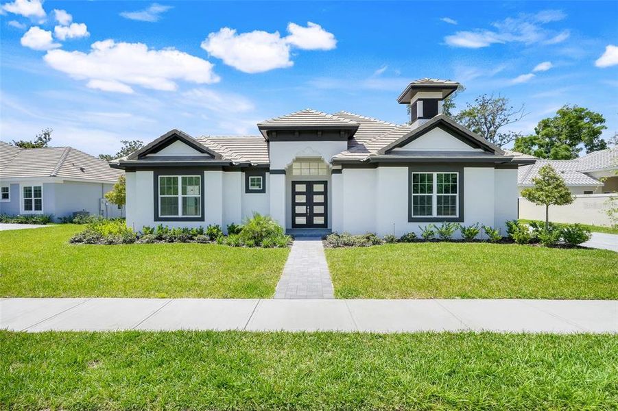 Front exterior of a new home in Toscana, Palm Coast, FL, highlighting curb appeal (Image 23).