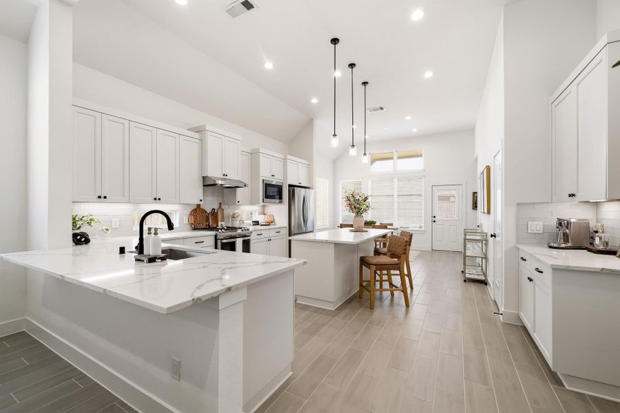 Designed with elevated living in mind, this luxurious kitchen features two sophisticated breakfast bars, creating an inviting setting for casual dining, morning coffee, and effortless entertaining with family and friends.