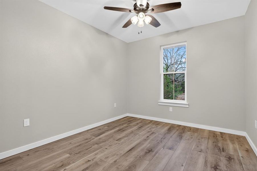 All secondary bedrooms feature ceiling vans, luxury vinyl plank flooring, and walk-in closets.