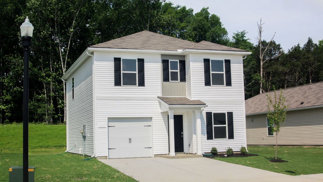 Front exterior of a new home in Parkside Point, Portland, TN, highlighting curb appeal (Image 1). Front exterior of a new home in Parkside Point, Portland, TN, highlighting curb appeal (Image 1).