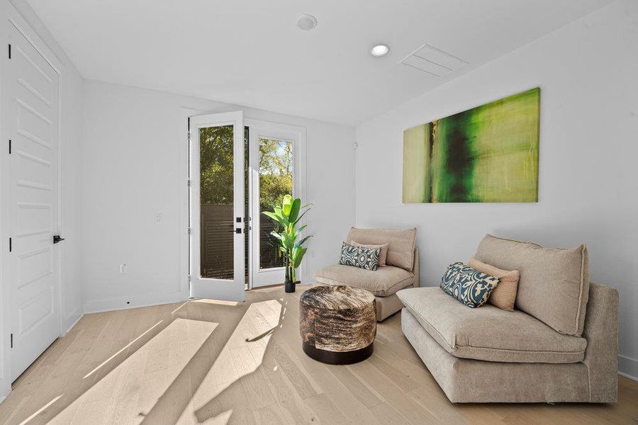 Sitting room with wood finished floors and recessed lighting Sitting room with wood finished floors and recessed lighting