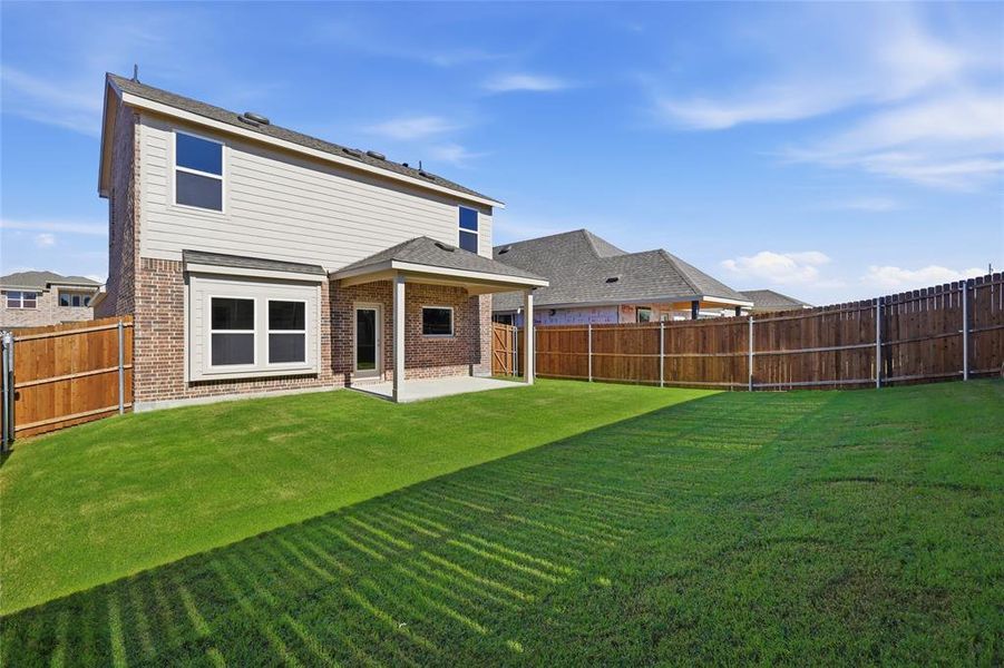 Expansive grass lawn with a full wooden privacy fence