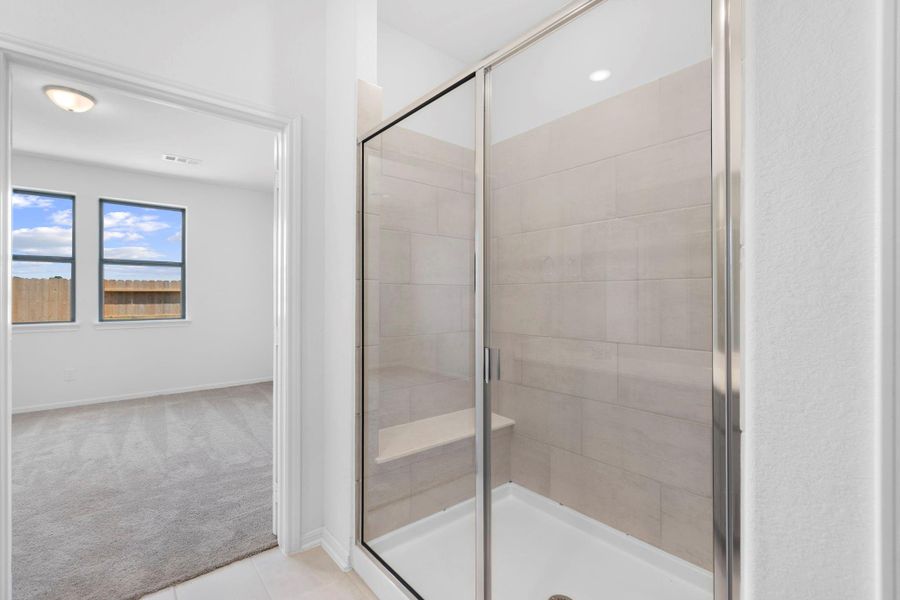This additional view of your primary bathroom features tile flooring, fresh paint, and large walk-in shower. This additional view of your primary bathroom features tile flooring, fresh paint, and large walk-in shower.