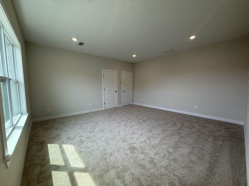 Spare room with light carpet and recessed lighting